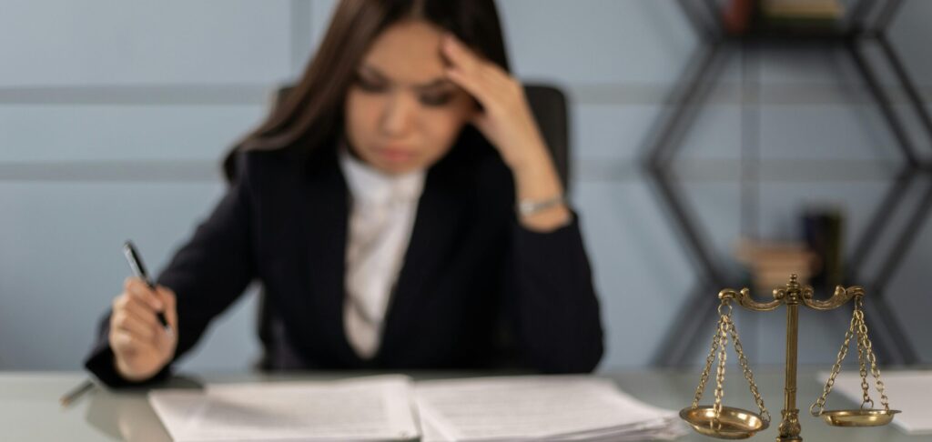 Frustrated lawyer trying reading a paper with hand on her head; trademark infringement